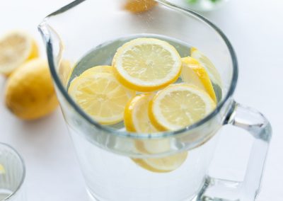slices of lemons in clear pitcher filled with water