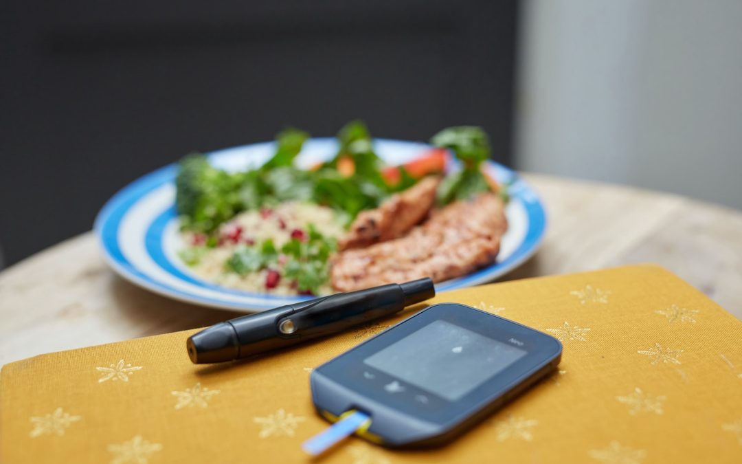 a plate of food and a cell phone on a table